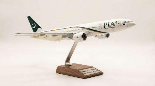 PIA Boeing 777 precision diecast scale model on walnut display pedestal